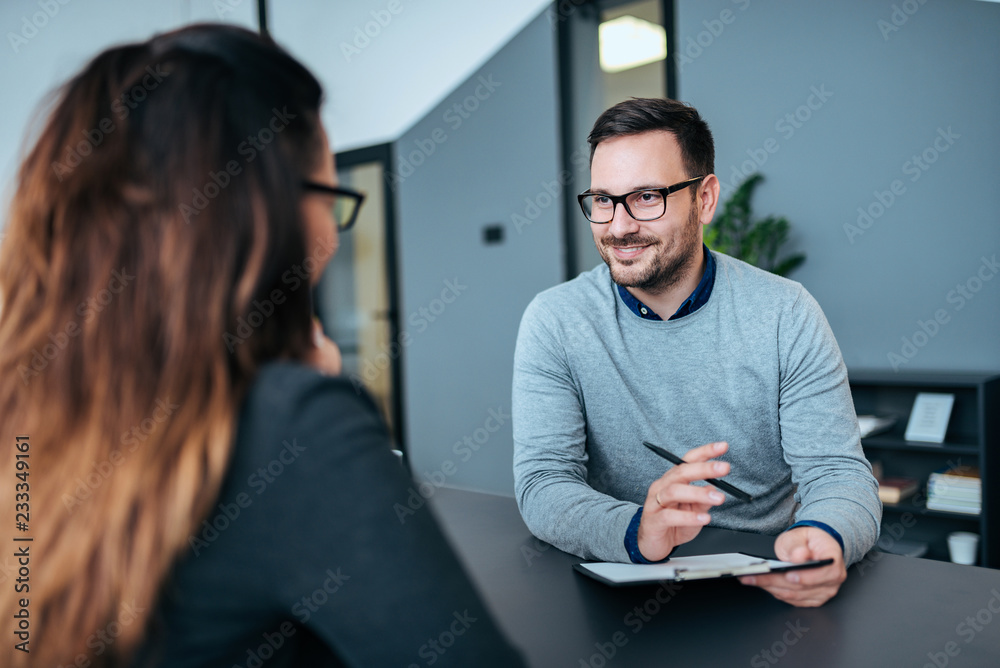 Female person having a job interview with a male recruiter.